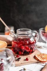 red tea into a glass cup, hibiscus, tea with red berries, vitamin drink, winter tea for colds, lemon, red currant, black currant, raspberry, honey, cinnamon, anise
