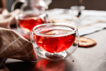 red tea into a glass cup, hibiscus, tea with red berries, vitamin drink, winter tea for colds, lemon, red currant, black currant, raspberry, honey, cinnamon, anise