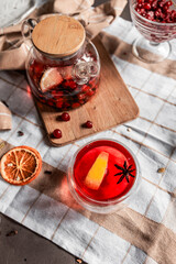 red tea into a glass cup, hibiscus, tea with red berries, vitamin drink, winter tea for colds, lemon, red currant, black currant, raspberry, honey, cinnamon, anise