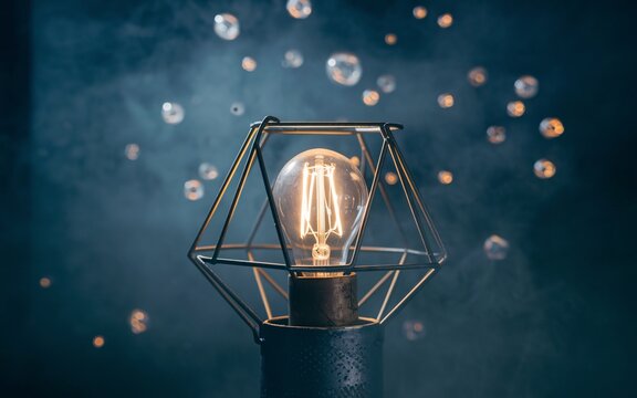 illuminated light bulb, Illuminated geometric lamp with floating orbs.