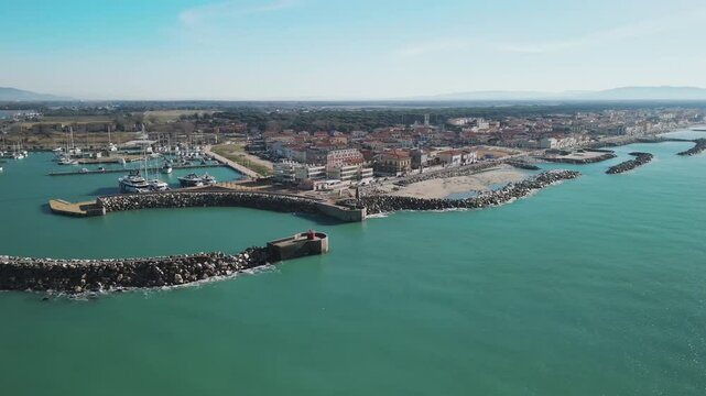 Aerial video above the coastline and Marina di Pisa in Italy