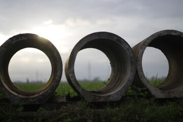 concrete pipes in rice fields, material that will be used to make agricultural irrigation channels