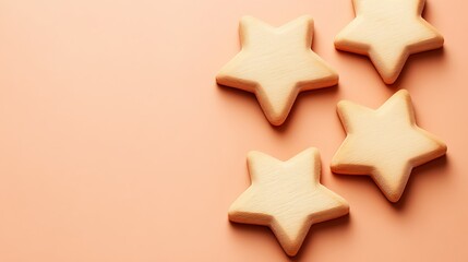 Four Star Shaped Cookies On Peach Background