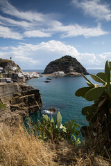 village Sant'Angelo, giant green rock in blue sea near Ischia Island, Italy