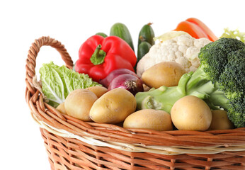 Different ripe vegetables in basket isolated on white