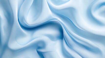 Obraz premium Soft, light blue silk fabric with elegant folds and drapes.