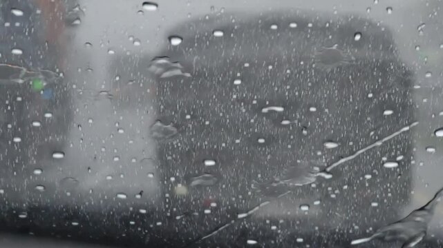 Blurred view from inside a traffic car in the rainy season in Asia, car drivers in the rainy season in Indonesia. climate change, rainy day on the street.