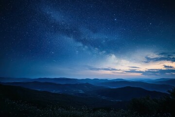 Naklejka premium Starry night sky over rolling hills and valleys with soft atmospheric light