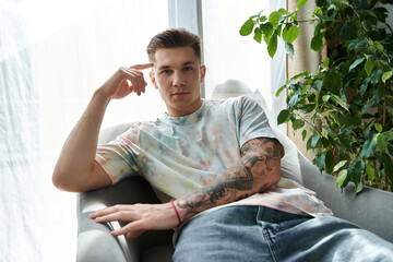 Young man with a prosthetic leg showcasing confidence amid a stylish indoor setting