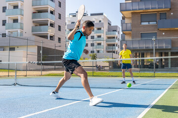 Fototapeta premium Pickleball players enjoying a sunny day of training and competition on the court