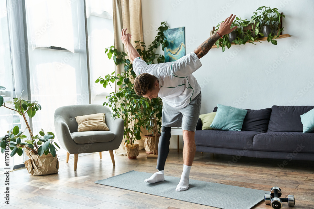 Wall mural A young man with a prosthetic leg strikes a yoga pose in a bright, plant filled living room