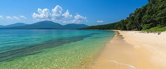 Obraz premium Idyllic beach with clear turquoise water, white sand, and lush green mountains under a blue sky.