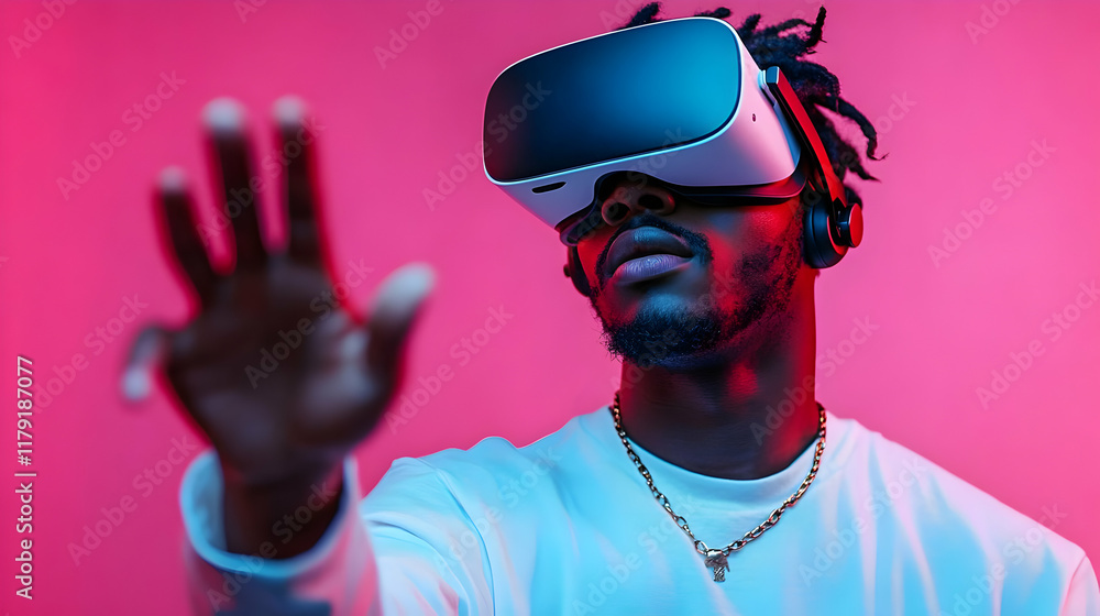 Poster man explores virtual reality with vr headset and interacts enthusiastically in pink studio