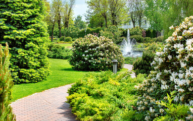 Serenity unfolds in a lush garden adorned with vibrant flowers and a shimmering fountain