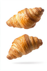 Freshly baked croissants floating in mid-air, isolated on white background.