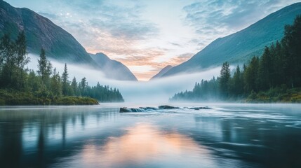 Fototapeta premium Misty sunrise over calm river between mountains.