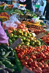 Vibrant market scene with fresh produce and shoppers.