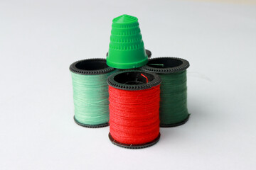 Travel Sewing Kit with Different Color Spools of Threads and Needles, Thimble and Buttons on white back ground