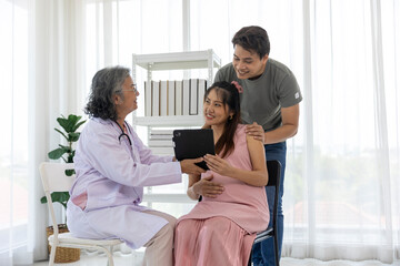 Obraz premium Pregnant Couple Consulting with Expert Doctor during a prenatal checkup