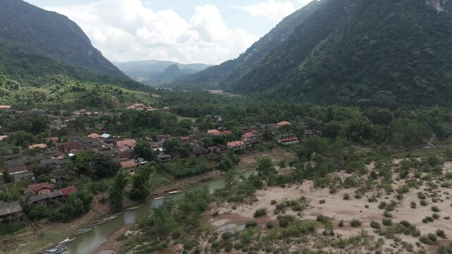 Circular drone footage above the remote village of Muang Ngoi in north Laos, heavily bombed during the secret war with CIA. Camera is moving from right to left 2-2
