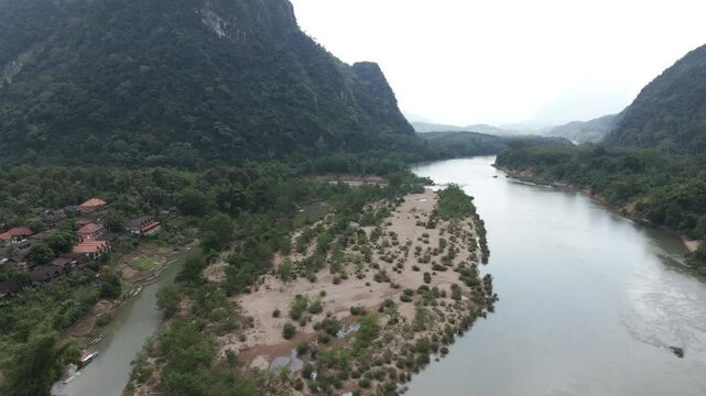 Circular drone footage above the remote village of Muang Ngoi in north Laos, heavily bombed during the secret war with CIA. Camera is moving from right to left 1-2