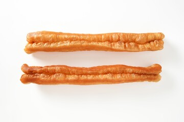 Top view of two golden brown fried doughs on a white background.