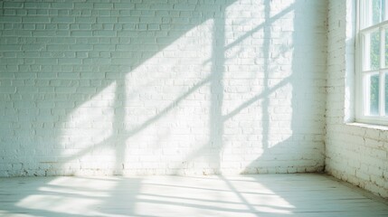 Obraz premium Sunlight streams through large windows in an empty white brick room, creating gentle shadows on the floor and walls