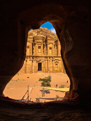 Petra, Jordan : ancient Monastery building in Petra (Ad Deir) from a cave // one of the Seven Wonders of the World (historical place in Arab countries)