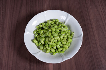 Boiled edamame on a white plate