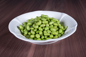 Boiled edamame on a white plate