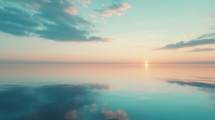Obraz premium Soft pastel colors illuminate the sky above a calm ocean during sunset, reflecting tranquility and beauty in the fading light