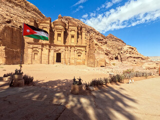 Petra, Jordan : The Jordanian flag flies in front of the ancient Monastery building in Petra (Ad Deir) (one of the Seven Wonders of the World) historical place