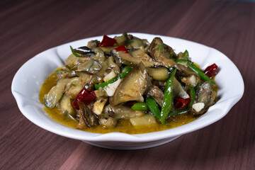 Vegetable fried eggplant on a white plate on the table