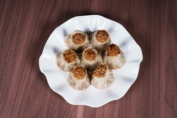 A breakfast treat on a plate with mushrooms and chicken