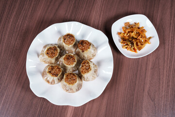 A breakfast treat on a plate with mushrooms and chicken
