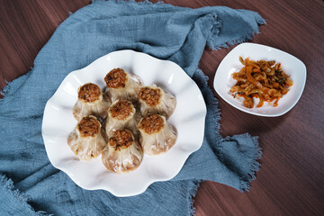 A breakfast treat on a plate with mushrooms and chicken