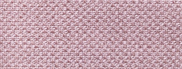 Texture light beige background from woven textile material with wicker pattern, macro. Structure vintage pink fabric