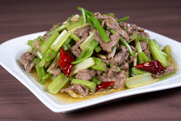 Celery stir-fried beef on a white plate