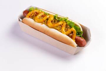 Appetizing hot dog in packaging on a light background.