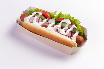 Appetizing hot dog in packaging on a light background.