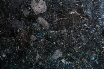 Labradorite and marble surface showcasing unique textures and colors in a natural setting