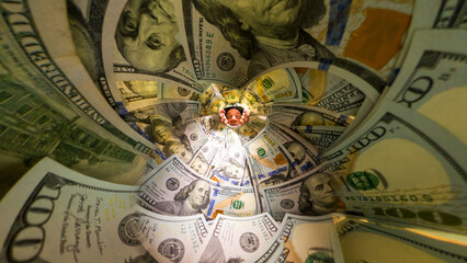 Wide-Angle View Inside a Jar Packed With Hundred-Dollar Bills as a Man Peeks Inside With a Curious Expression, Highlighting the Depth and Perspective of the Money. Observation of Financial Wealth.