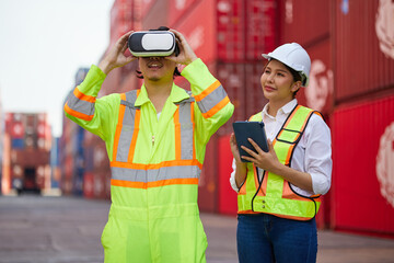 worker or engineer wearing virtual reality glasses(VR) in containers warehouse storage