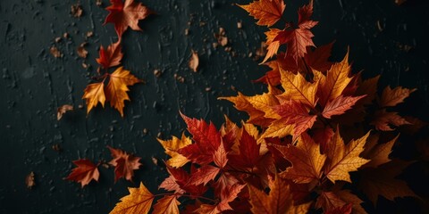 A dark textured background with vibrant orange autumn leaves scattered around, creating a rich and moody fall aesthetic.
