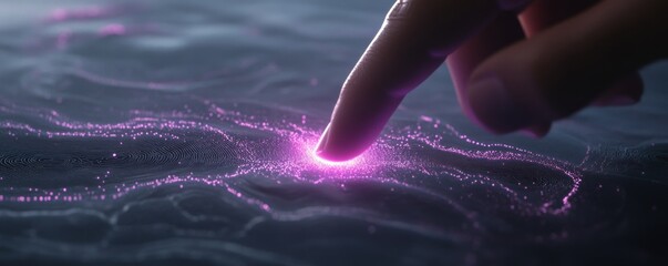 Fingertip touching glowing particles on dark surface.