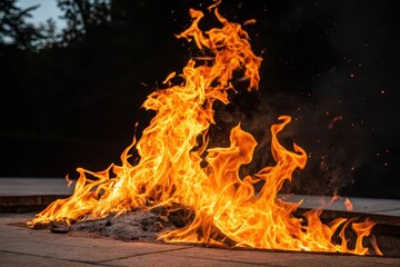 Fototapeta premium Fiery blaze consuming fuel, creating a dramatic display of intense heat and light, with sparks dancing in the dark night sky