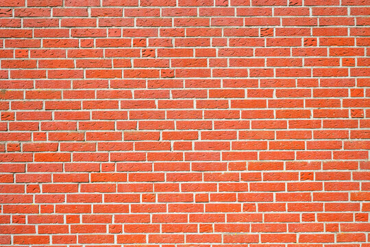 Red brick wall as a template for a background. Red bricks.
