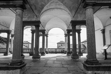 Symmetric colonnade at the famous Oropa Shrine, close to the city of Biella, Italy. Monochromatic.