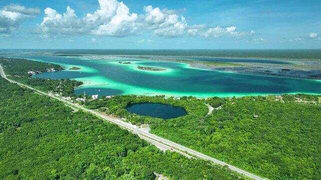 Drone shot of Bacalar lagoon of seven colors, cenote, Scenic driving through coastal landscape, Quintana Roo