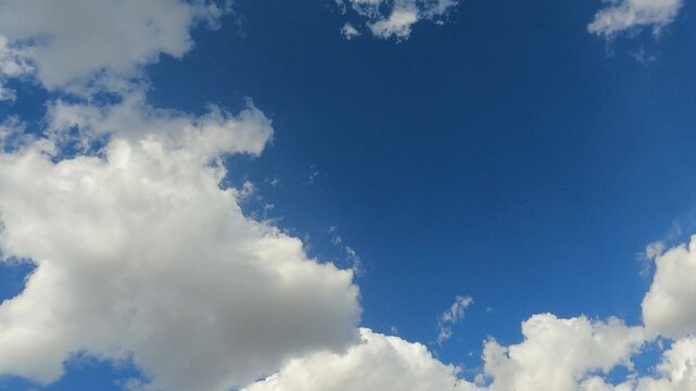 Blue sky with clouds in time lapse motion